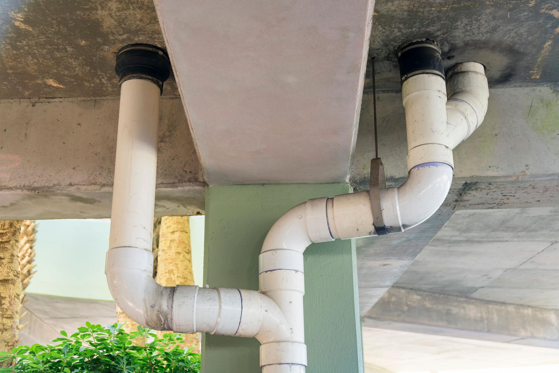 White pvc drain pipes below the parking garage building in Destin, Florida